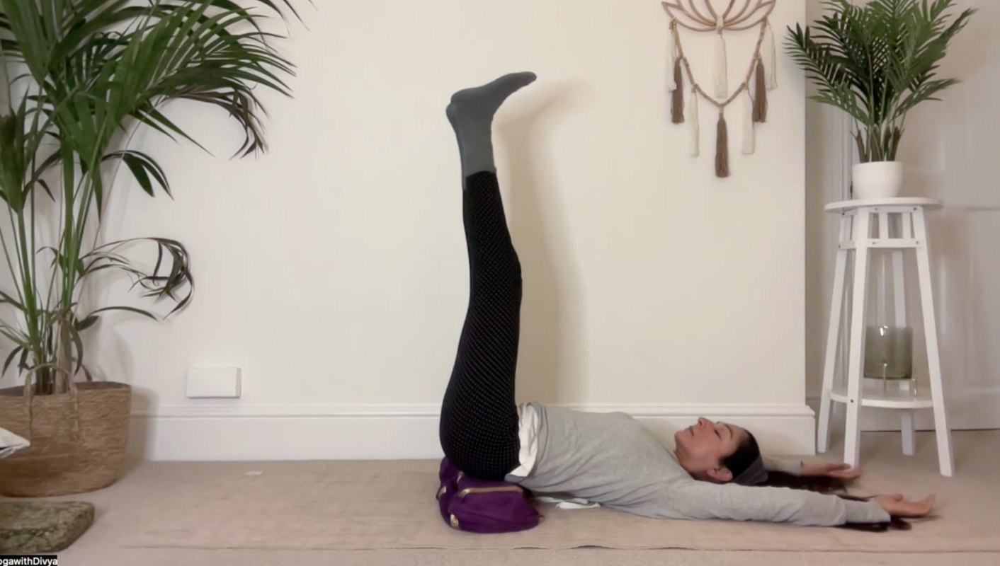 yoga teacher divya in viparita karani, legs up
